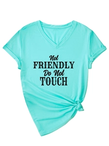 Detail of mint green V-neck T-shirt showing Not Friendly slogan and stylish front knot