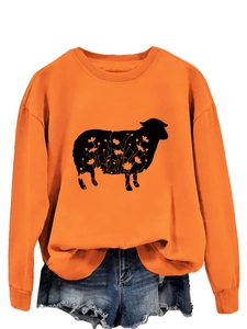 Detail of orange crewneck sweatshirt with black sheep silhouette and floral pattern design