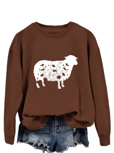 Detail of caramel crewneck sweatshirt featuring a white floral sheep graphic print