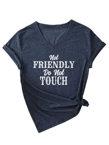 Detail of V-neck grey tee with Not Friendly Do Not Touch print and stylish side knot