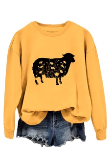 Detail of ginger yellow crewneck sweatshirt with floral sheep silhouette graphic
