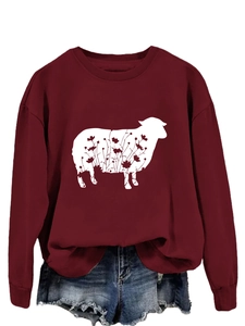 Detail of burgundy crewneck sweatshirt with sheep floral print and denim shorts