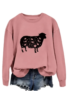 Detail of pink crewneck sweatshirt featuring a floral sheep graphic and soft knit texture