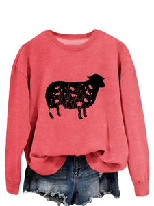 Close-up of pink crewneck sweatshirt with a floral sheep silhouette graphic on fabric