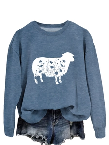 Detail of blue crewneck sweatshirt featuring a floral sheep print and ribbed cuffs