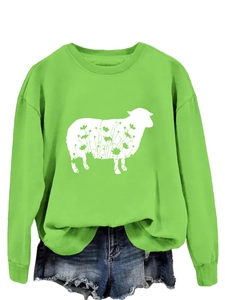 Detail of green crewneck sweatshirt featuring a white lamb silhouette with floral patterns