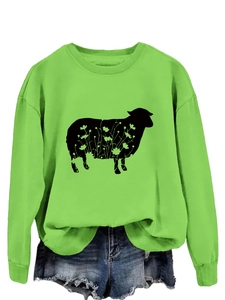 Close-up of bright green crew neck sweatshirt featuring a black sheep and floral print