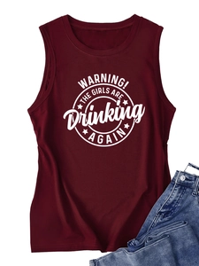 Detail of burgundy round neck tank top with white circular graphic print and denim jeans