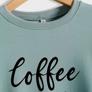 Sage green crewneck sweatshirt featuring black Coffee script embroidery and ribbed collar