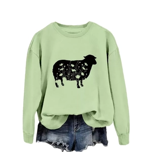 Light green crewneck sweatshirt with black floral sheep graphic and denim shorts