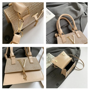 Detailed close-up of apricot leather handbag with sparkling rhinestones and gold V detail