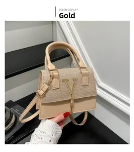 Detail of champagne gold crossbody bag featuring sparkly sequins and a V-logo with tassel