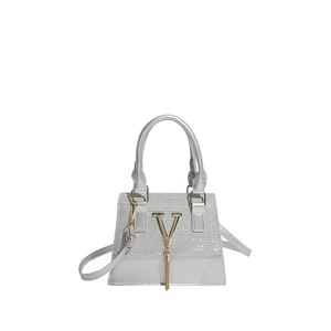 Silver textured handbag with gold V metal logo and tassel charm on white background