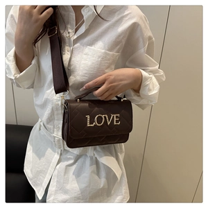 Sac à bandoulière matelassé marron avec lettrage LOVE doré et large sangle sur modèle