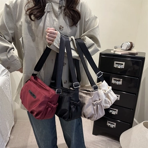 Waterproof nylon crossbody bags in various colors including burgundy and black