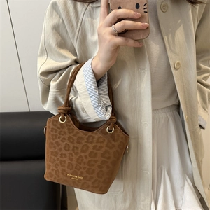 Brown leopard print bucket bag with chunky rope handles and gold hardware details
