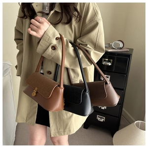 Three leather shoulder bags in caramel and black with velvet flaps and gold clasps