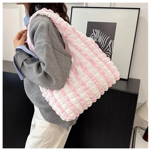 Detailed view of large pink and white striped pleated shoulder bag with soft texture