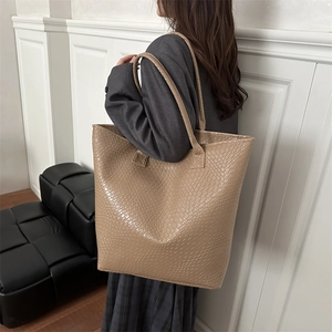 Large woven leather tote bag for women in earthy brown, perfect for daily commuting use