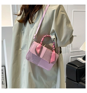 Detail of pink fashion handbag with sequin fabric and elegant silk ribbon handle