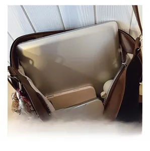 Top view of spacious interior showing laptop, tablet, and cosmetics in a tote bag