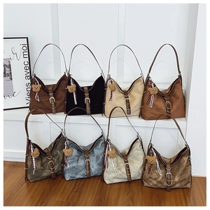Collection of hobo shoulder bags in eight colors featuring bear charms and buckles