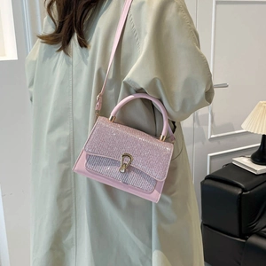 Pink glitter crossbody bag with gold metal lock buckle and elegant top handle for women
