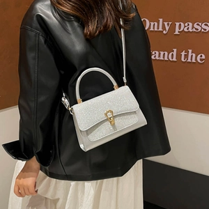 Silver glitter crossbody bag with gold handle and metallic lock for party fashion