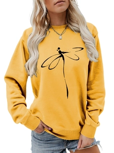 Detail showing a minimalist black dragonfly graphic on a bright yellow crewneck sweatshirt