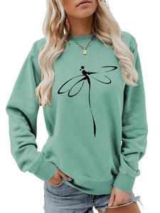 Close-up of mint green sweatshirt featuring a minimalist black dragonfly line art print