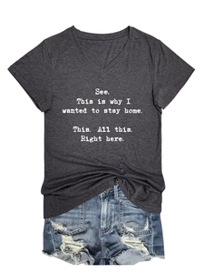 Flat lay of women's grey V-neck T-shirt with white text and ripped denim shorts set