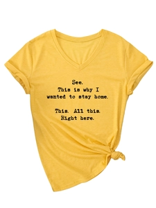 Detail of V-neck yellow t-shirt featuring front slogan text and bottom hem knot design