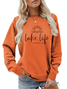 Detail of burnt orange sweatshirt showing Lake Life text and sun graphic on high-quality fabric