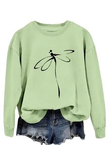 Detail of dragonfly line art print on avocado green crewneck sweatshirt with raw hem denim shorts