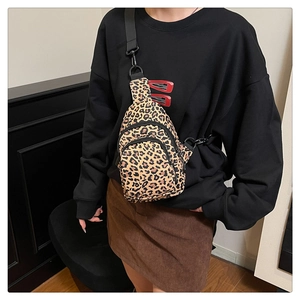 Close-up of leopard print chest bag with adjustable strap worn by a female model