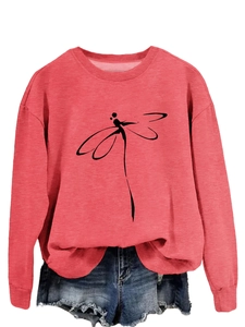 Close-up of coral pink sweatshirt with minimalist black dragonfly line art and crew neck