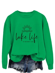 Detail of green Lake Life Is The Best Life sweatshirt with graphic print and denim shorts