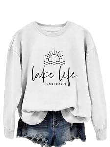 Detailed view of the 'lake life is the best life' print on a white crewneck sweatshirt