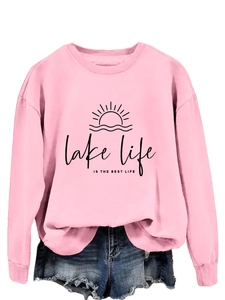 Detail of pink Lake Life Is The Best Life sweatshirt with graphic print and denim shorts