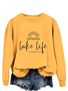 Detail of lake life is the best life graphic print on mustard yellow cotton sweatshirt