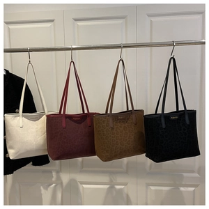 Close-up of leopard print tote bags with fashion metal plaque and color options