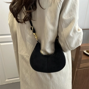 Chic black crescent shoulder bag with matte texture and elegant gold chain strap