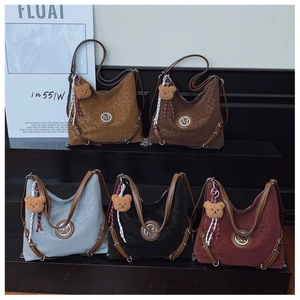 Detailed display of leopard print suede shoulder bags in five colors with metal M logo