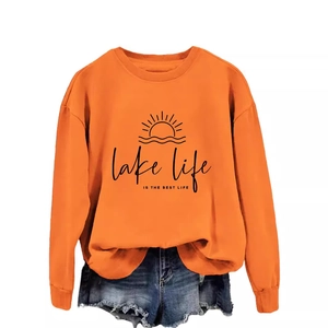 Orange crewneck sweatshirt featuring Lake Life is the Best Life print with denim shorts