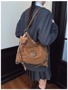 Brown suede hobo bag with leopard texture, metal M logo, and cute plush bear charm