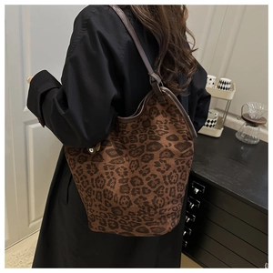 Detail of soft leopard print tote bag showing texture and slim leather shoulder strap