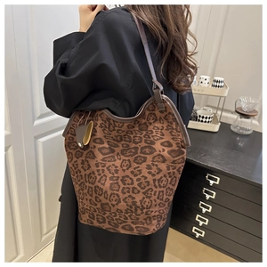 Leopard print tote bag detail showing matte texture and slim leather shoulder strap