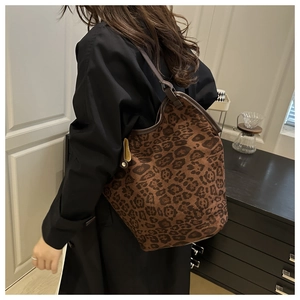 Close-up of leopard print tote bag with premium suede texture and leather strap