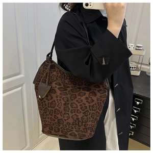 Macro detail of vintage leopard print tote bag with premium faux fur and brown strap