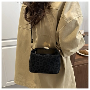 Detail of leopard print bucket bag with vintage gold metal clasp and adjustable strap